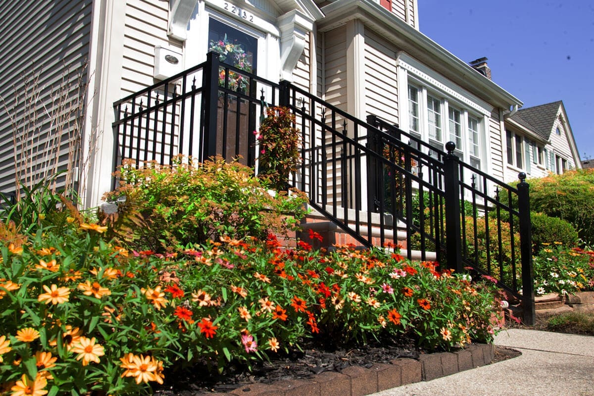 _F9S9787-(1) inviting front porch with wooden door hanging baskets