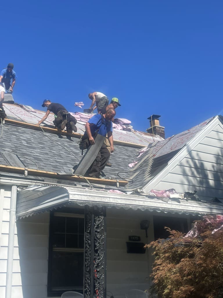 7fbc126f-a799-44f8-bba7-ee55afcfaeb2 Wayne Craft working on a roof